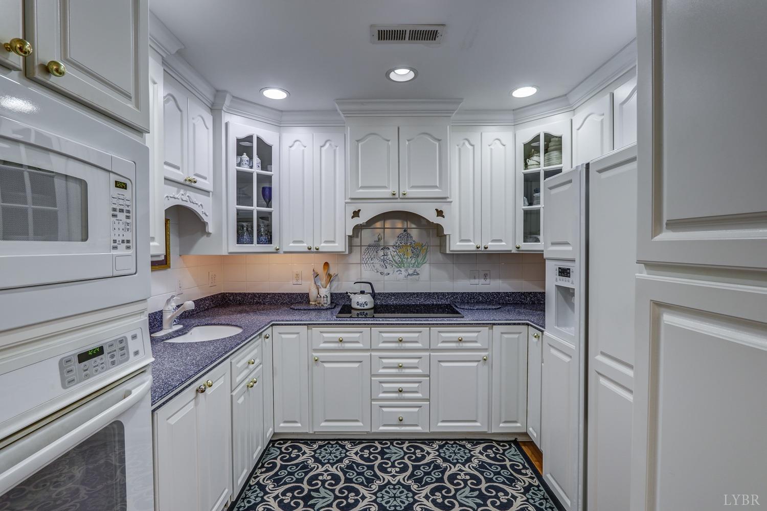 117 Sailview Drive Forest, VA 24551 - Photo 18 of 55 a kitchen with granite countertop a sink stove and cabinets