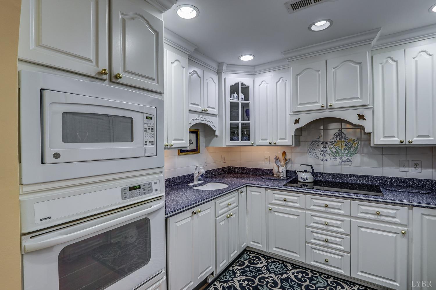 117 Sailview Drive Forest, VA 24551 - Photo 20 of 55 a kitchen with granite countertop white cabinets stainless steel appliances and sink