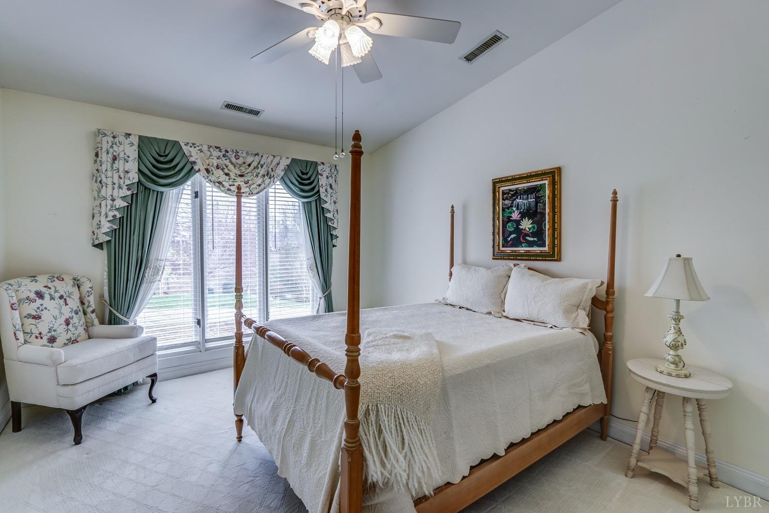 117 Sailview Drive Forest, VA 24551 - Photo 36 of 55 a bedroom with a bed and a chandelier