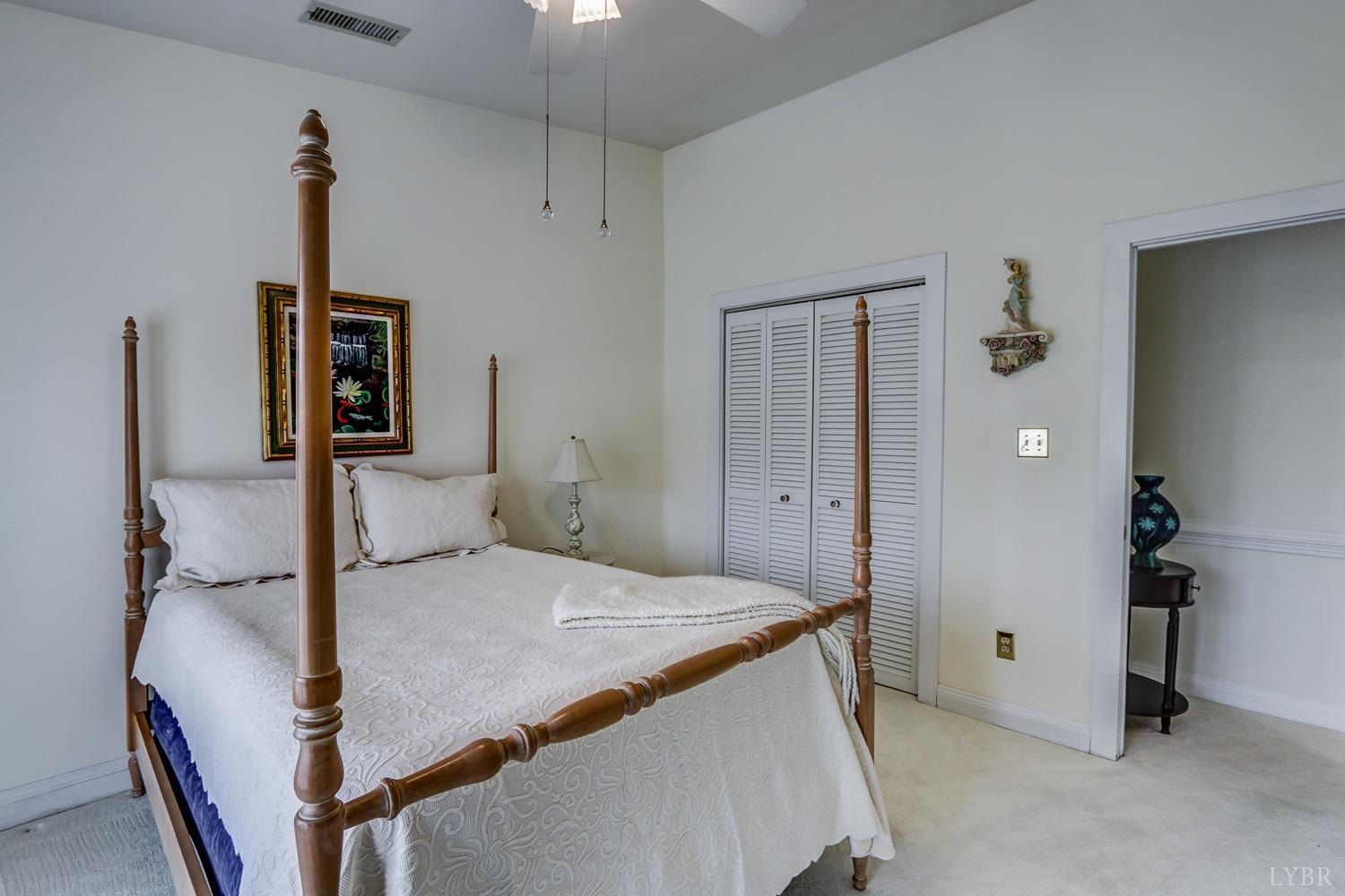 117 Sailview Drive Forest, VA 24551 - Photo 37 of 55 a bedroom with a bed and a chandelier