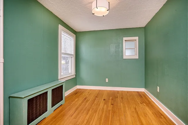 a view of room with wooden floor and fan