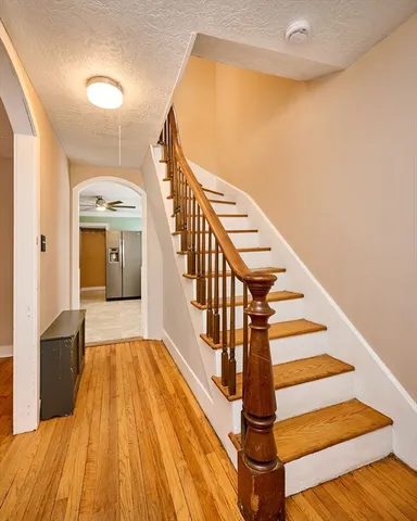 a view of entryway and hall with wooden floor