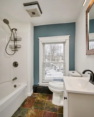 a bathroom with a sink a toilet and bathtub