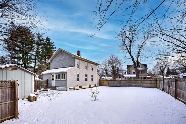 a view of a house with snow on the road