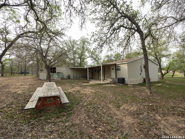 135 Savannah Ridge Von Ormy, TX 78073 - Photo 11 of 45 a small house with trees in front of it