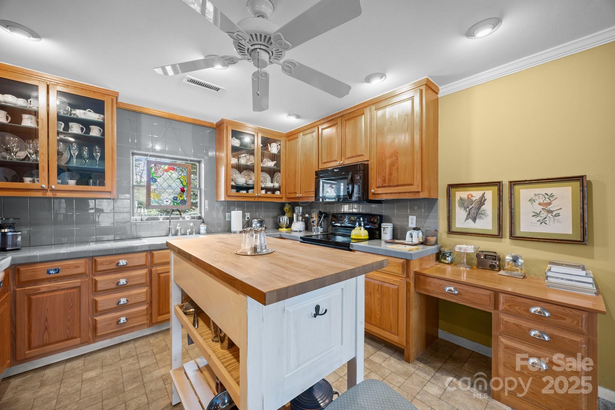 457 Overlook Drive Spruce Pine, NC 28777 - Photo 16 of 33 a kitchen with a stove window and cabinets