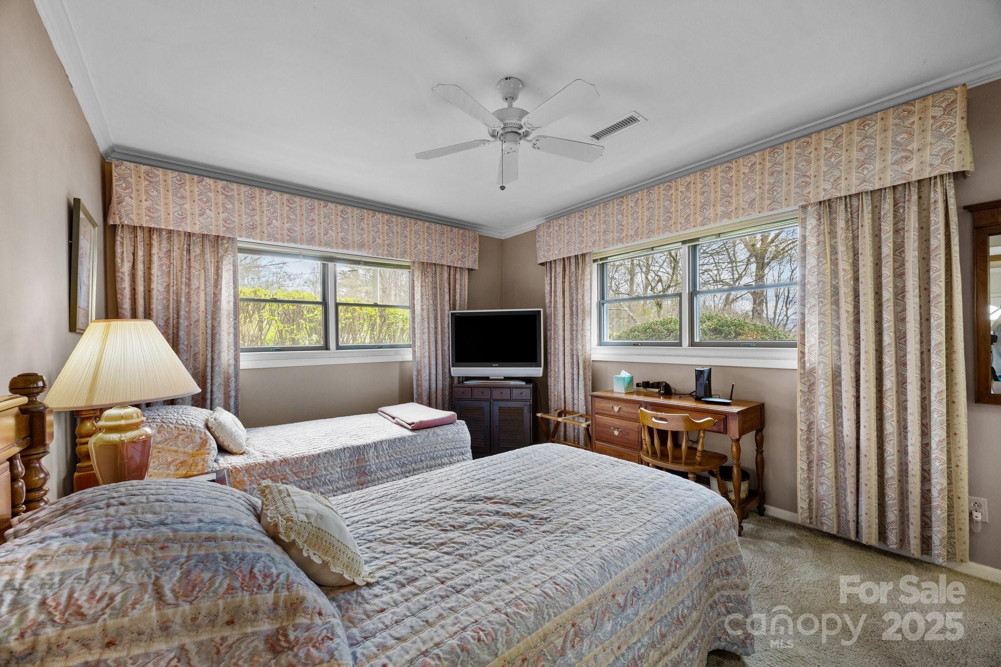 457 Overlook Drive Spruce Pine, NC 28777 - Photo 17 of 33 a bedroom with a bed and a chandelier