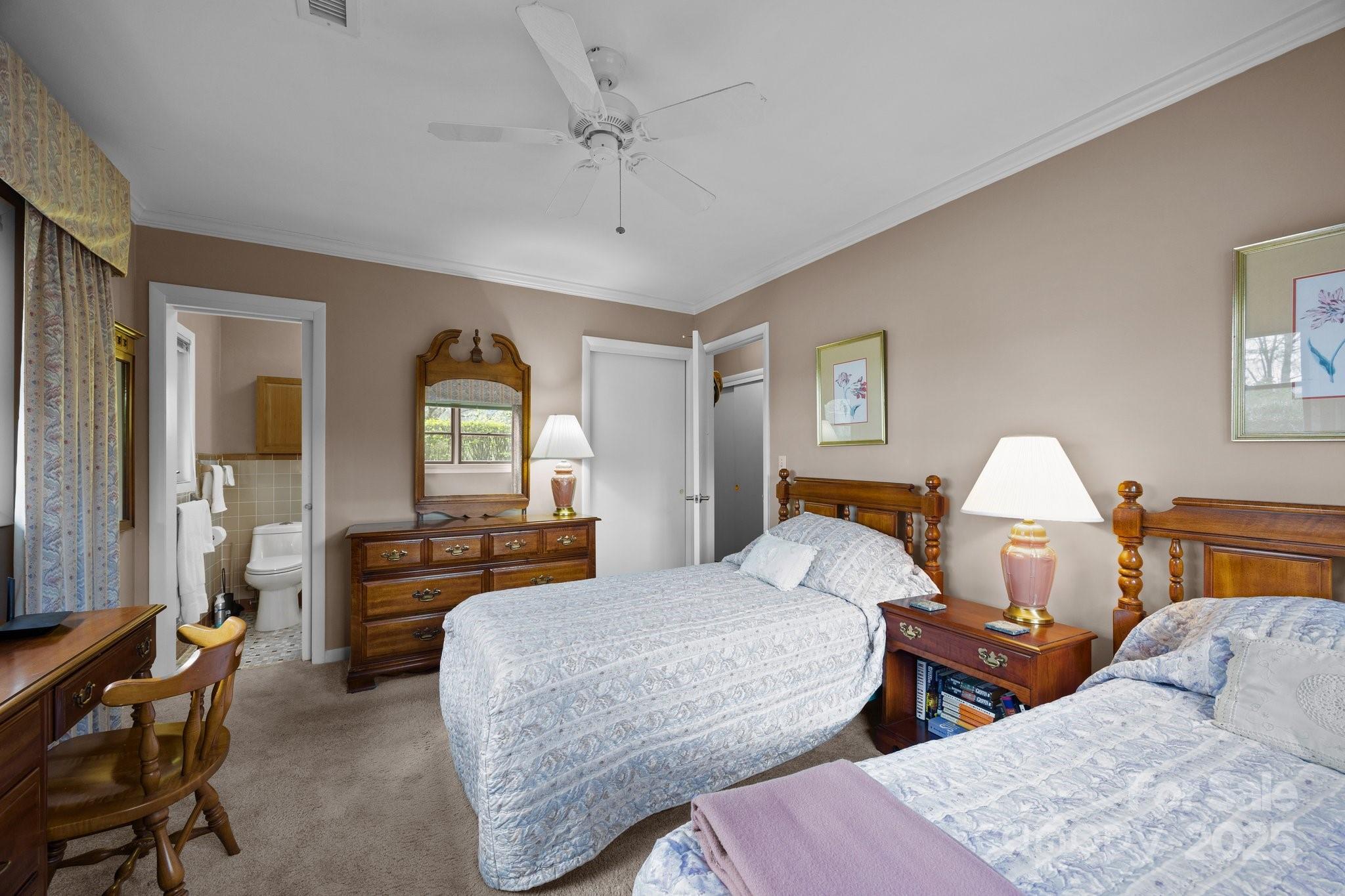 457 Overlook Drive Spruce Pine, NC 28777 - Photo 18 of 33 a bedroom with two beds and large windows