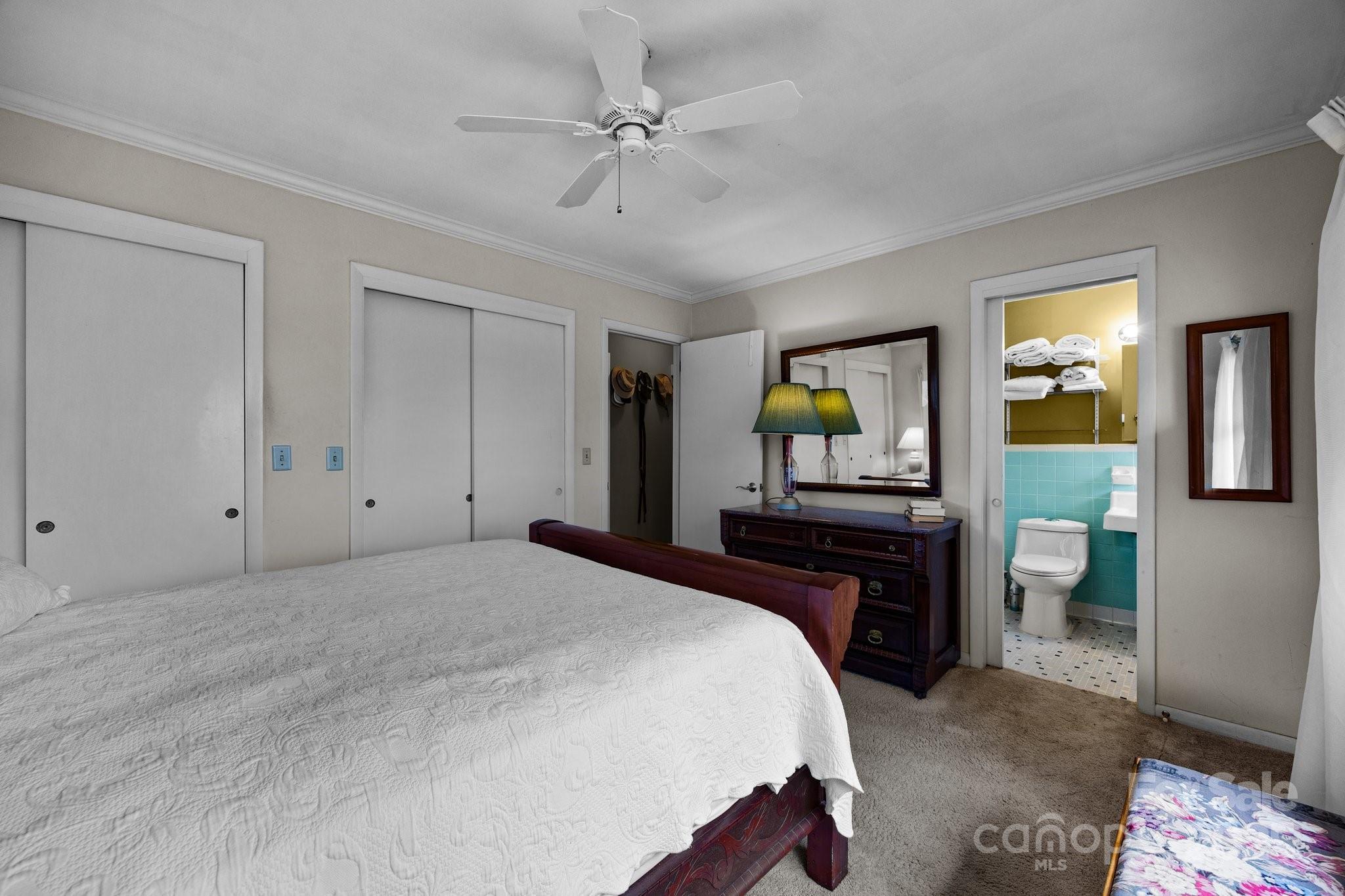 457 Overlook Drive Spruce Pine, NC 28777 - Photo 21 of 33 a bedroom with a bed and a chandelier