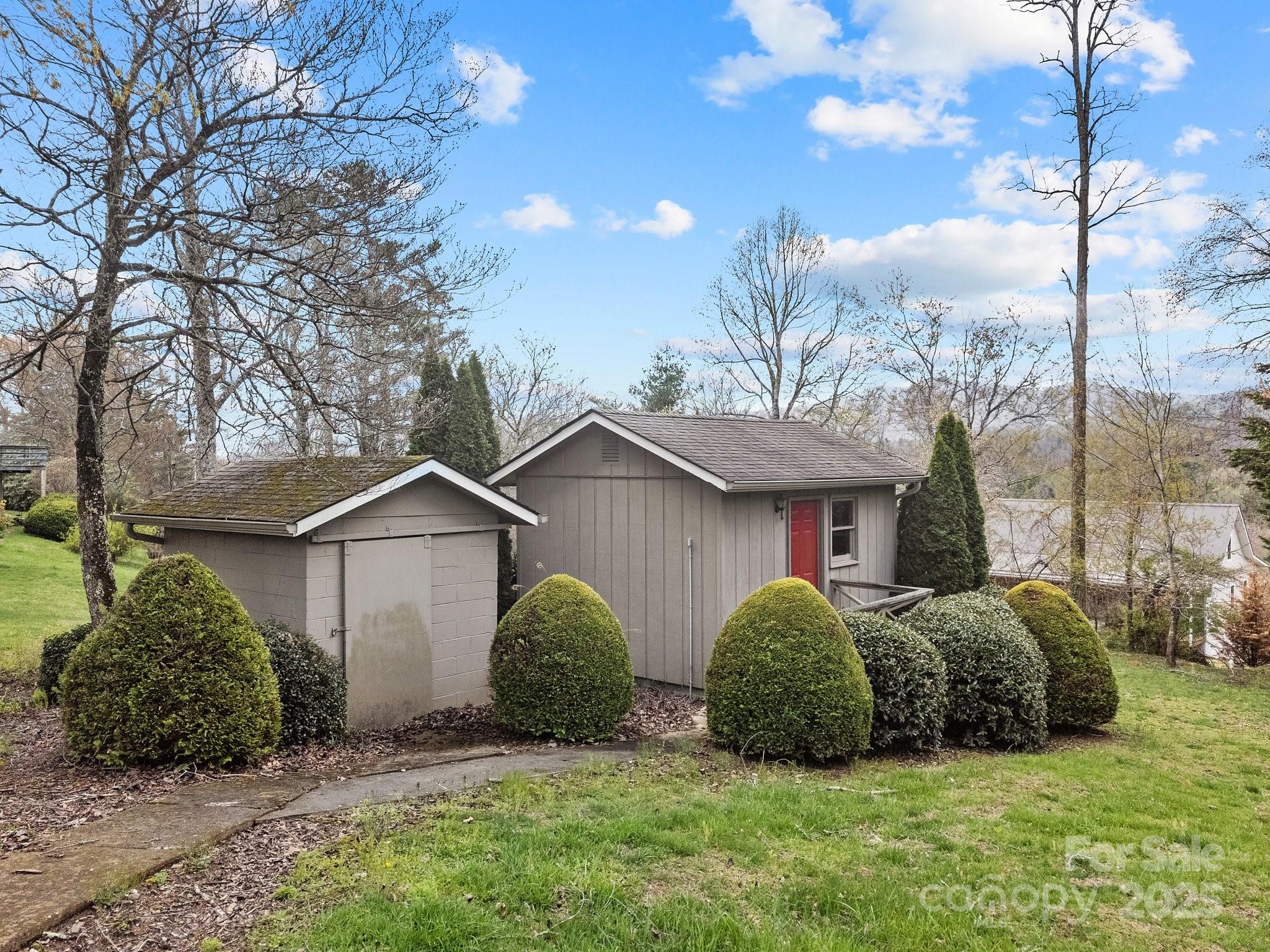 457 Overlook Drive Spruce Pine, NC 28777 - Photo 30 of 33 a view of a house with a yard and plants