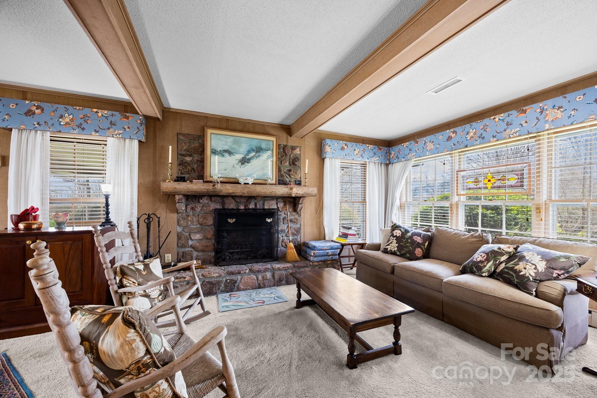 457 Overlook Drive Spruce Pine, NC 28777 - Photo 5 of 33 a living room with furniture a large window and a fireplace