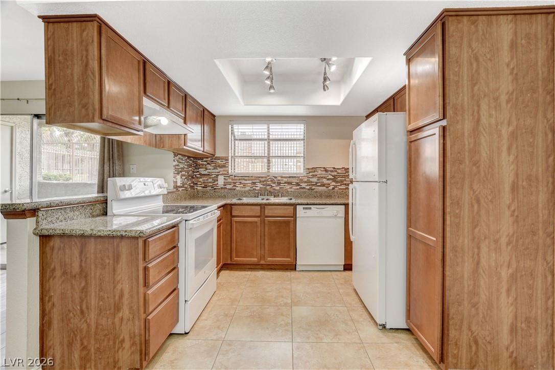 7200 West Pirates Cove Road, Unit 1026 Las Vegas, NV 89145 - Photo 12 of 35 This efficient kitchen offers ample cabinetry, modern appliances, and a convenient layout for daily living.