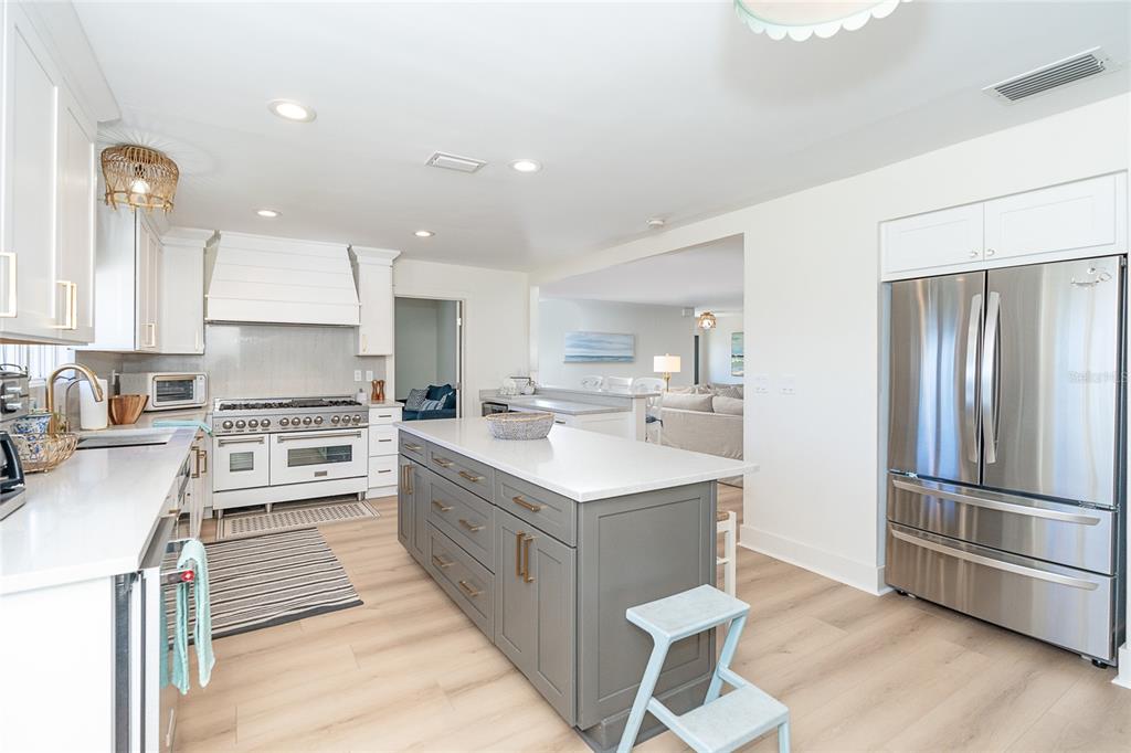 320 Anchor Row Placida, FL 33946 - Photo 12 of 41 a kitchen with stainless steel appliances granite countertop a refrigerator oven a sink dishwasher and white cabinets with wooden floor