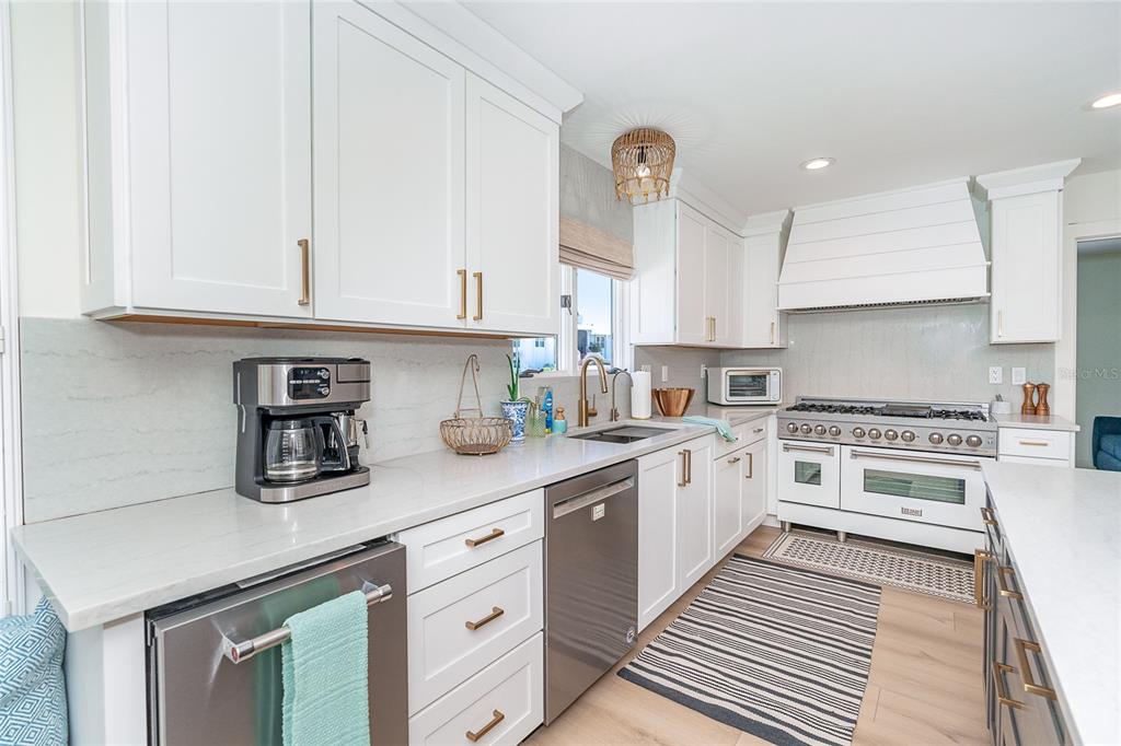 320 Anchor Row Placida, FL 33946 - Photo 13 of 41 a kitchen with stainless steel appliances granite countertop a stove a sink and white cabinets