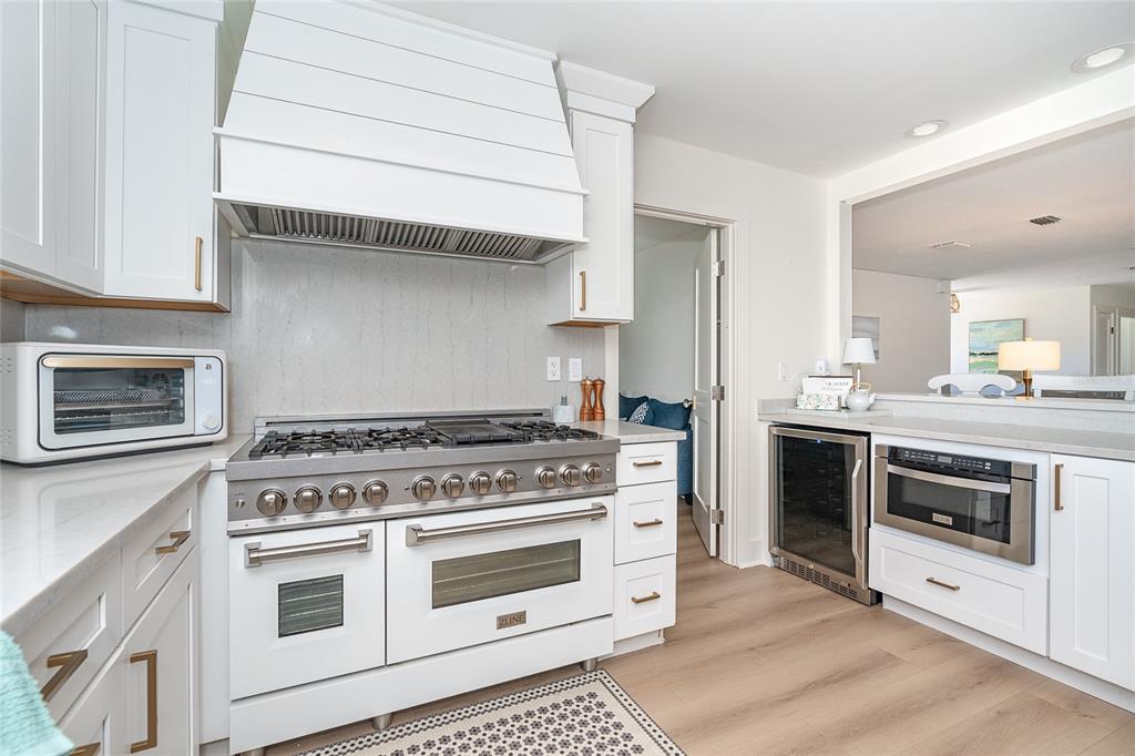 320 Anchor Row Placida, FL 33946 - Photo 14 of 41 a kitchen with stainless steel appliances white cabinets and a stove
