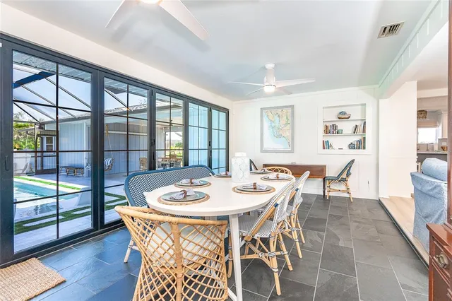 a dining room with furniture a chandelier and wooden floor