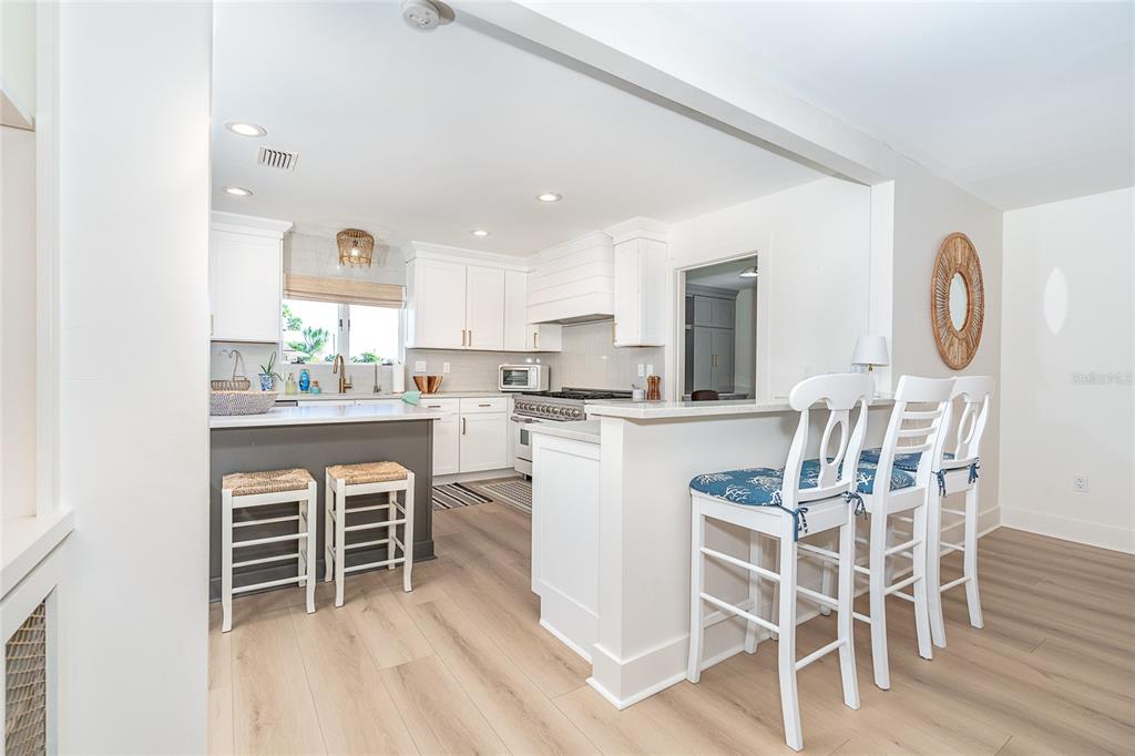 320 Anchor Row Placida, FL 33946 - Photo 10 of 41 a kitchen with a dining table chairs and white cabinets