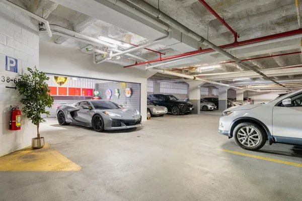 a view of parking garage with cars parked