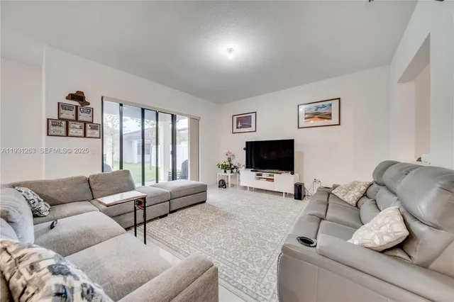 a large kitchen with a table and chairs in it