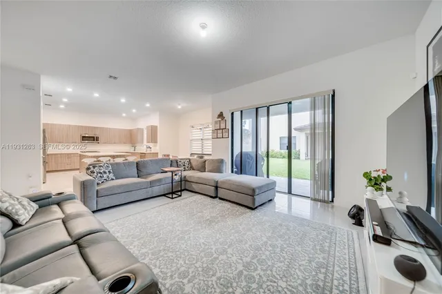 a kitchen with a dining table chairs and white appliances