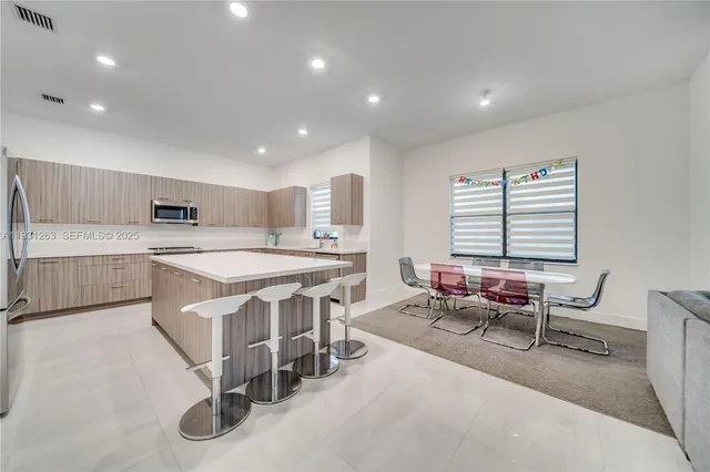a kitchen with cabinets appliances and a window