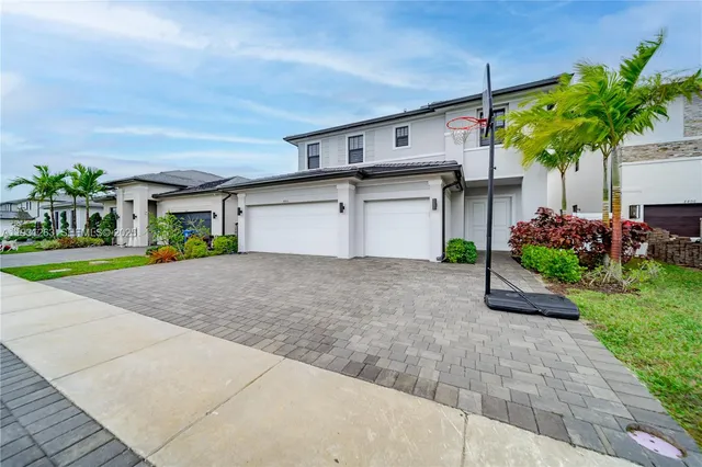 a front view of house with a yard and a garage