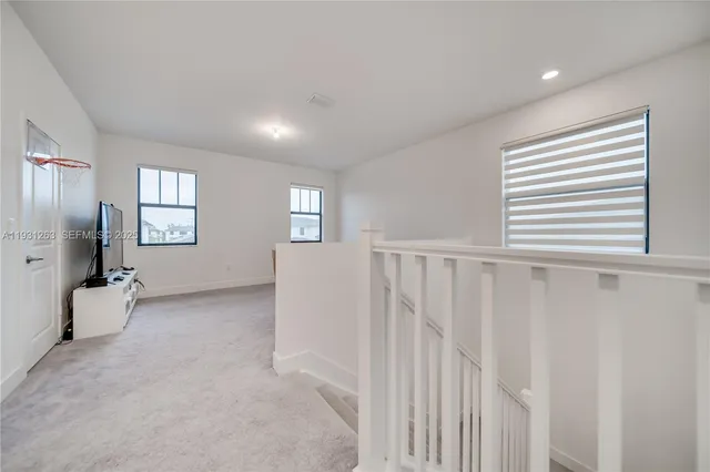 a bathroom with a bathtub a double vanity sink and mirror