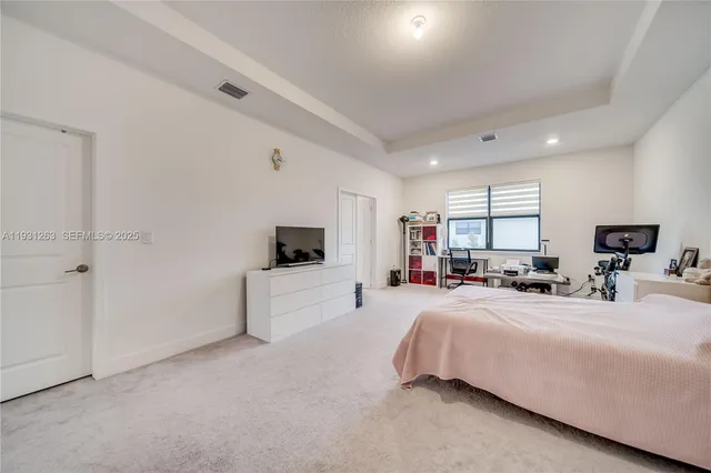 a bedroom with two beds and window