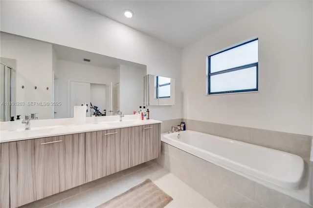 a view of a house with backyard and a tree