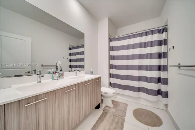 a front view of a house with a garden and plants