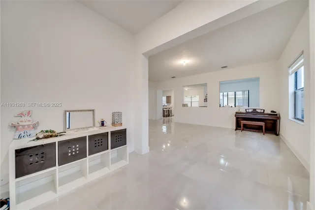 a view of a kitchen with a white cabinets and wooden floor