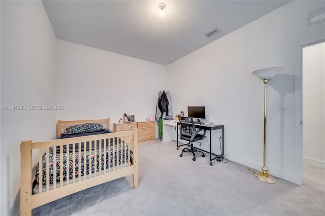 a view of a house with backyard and a garden