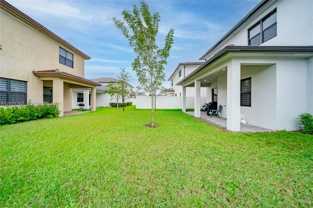 an aerial view of a house with a garden and mountain view in back