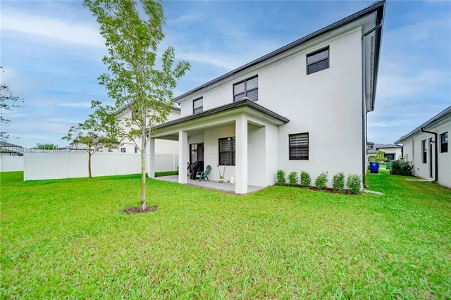an aerial view of a house with a garden and swimming pool