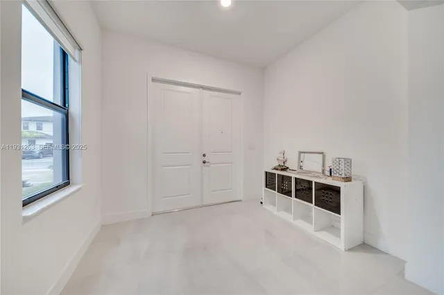 a view of a livingroom with furniture and a mirror