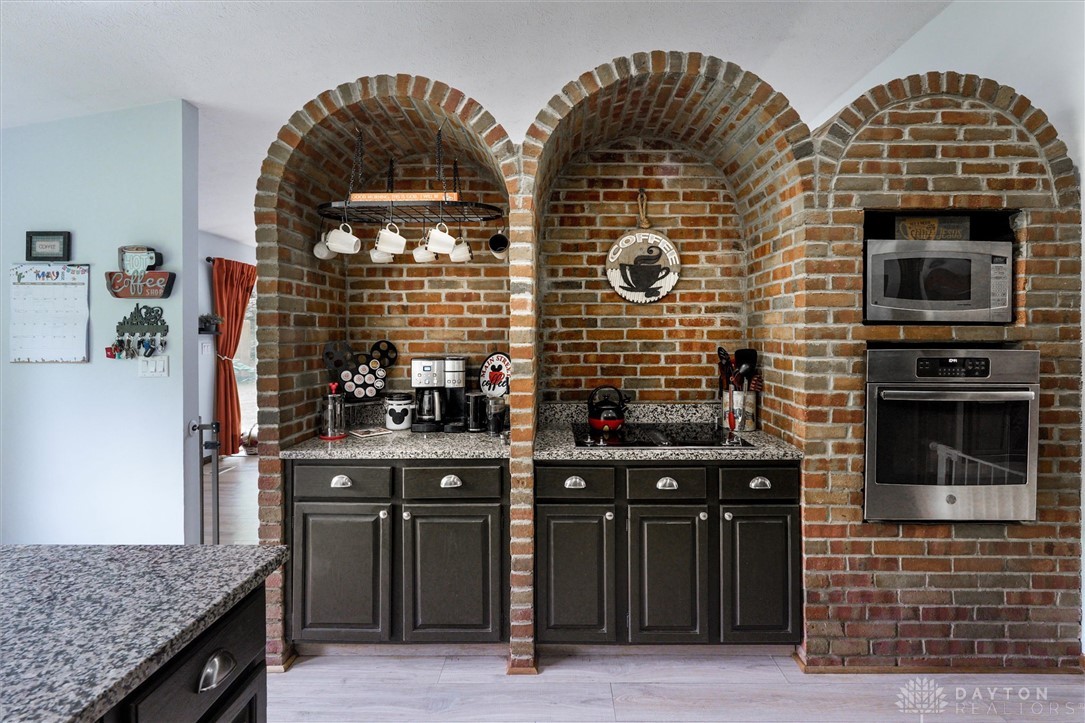 2165 Stewart Road Xenia, OH 45385 - Photo 9 of 59 This kitchen showcases charming brick archways and contemporary appliances, creating a unique culinary space.