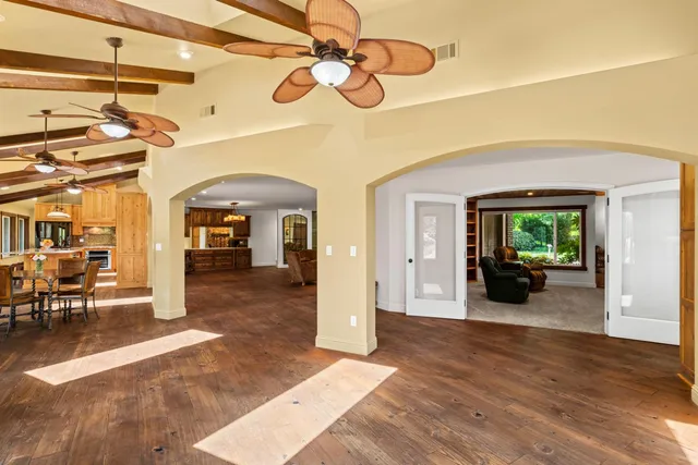 a bathroom with a granite countertop sink and a toilet