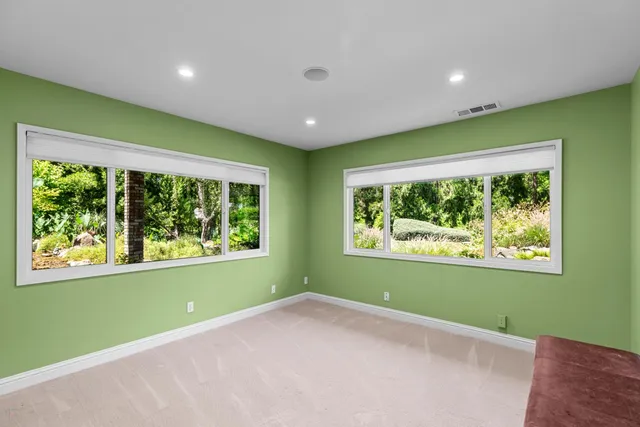 a view of a patio with table and chairs under an umbrella