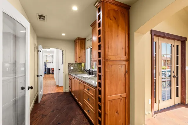 a view of a kitchen with a stove cabinets and a floor to ceiling window