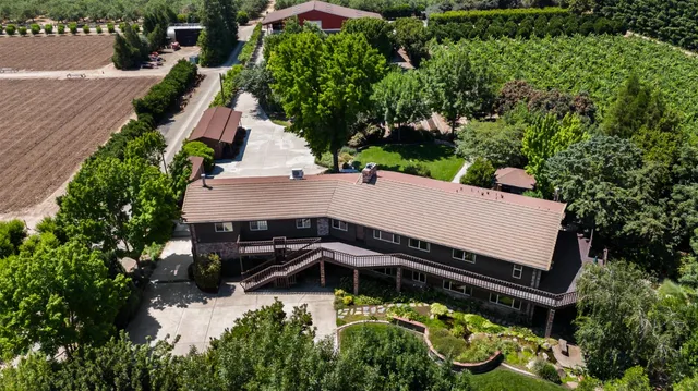 a kitchen with stainless steel appliances granite countertop a sink a stove and a wooden floors
