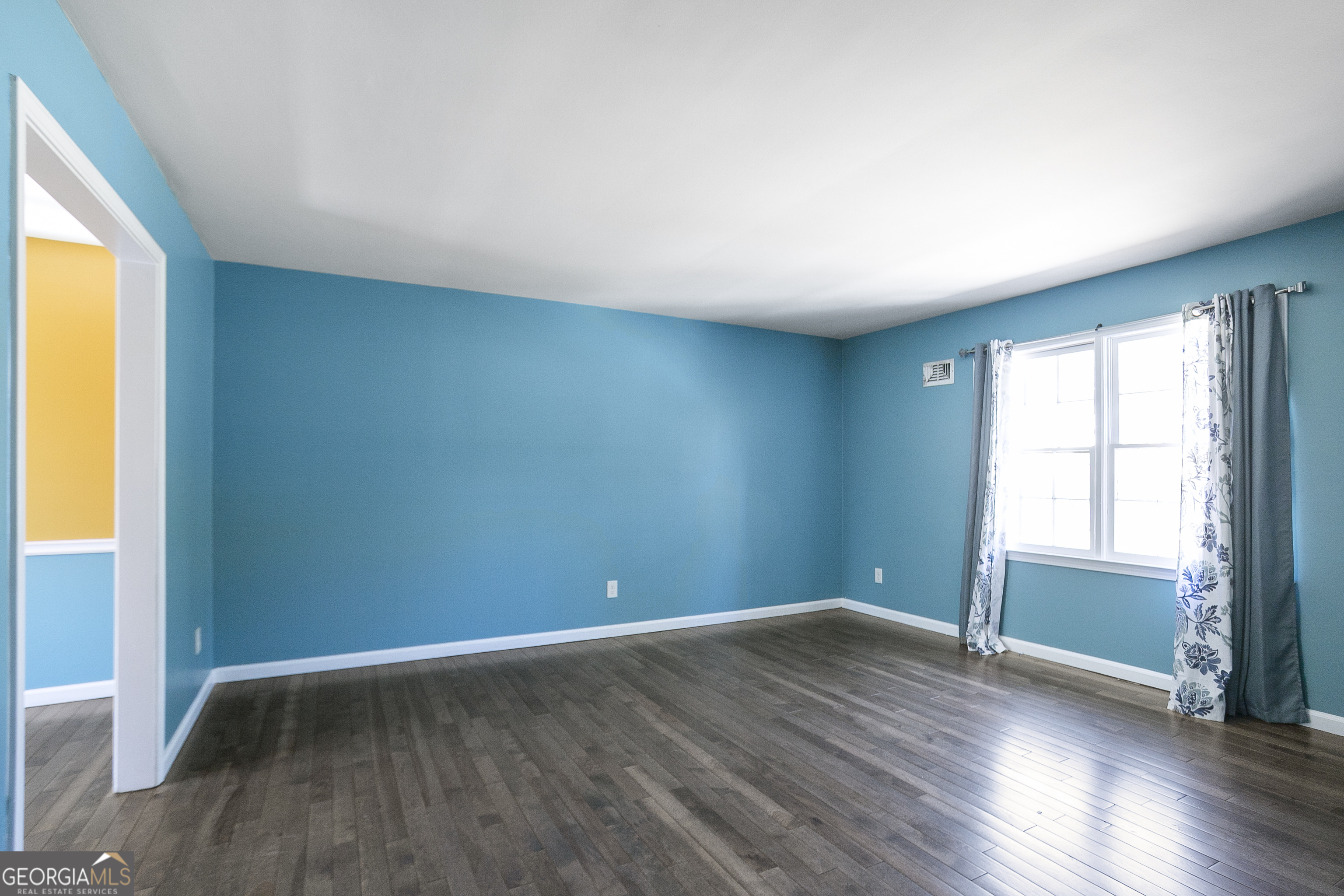 3959 Emerald Springs Court, Unit 3 Decatur, GA 30035 - Photo 11 of 27 an empty room with wooden floor and windows