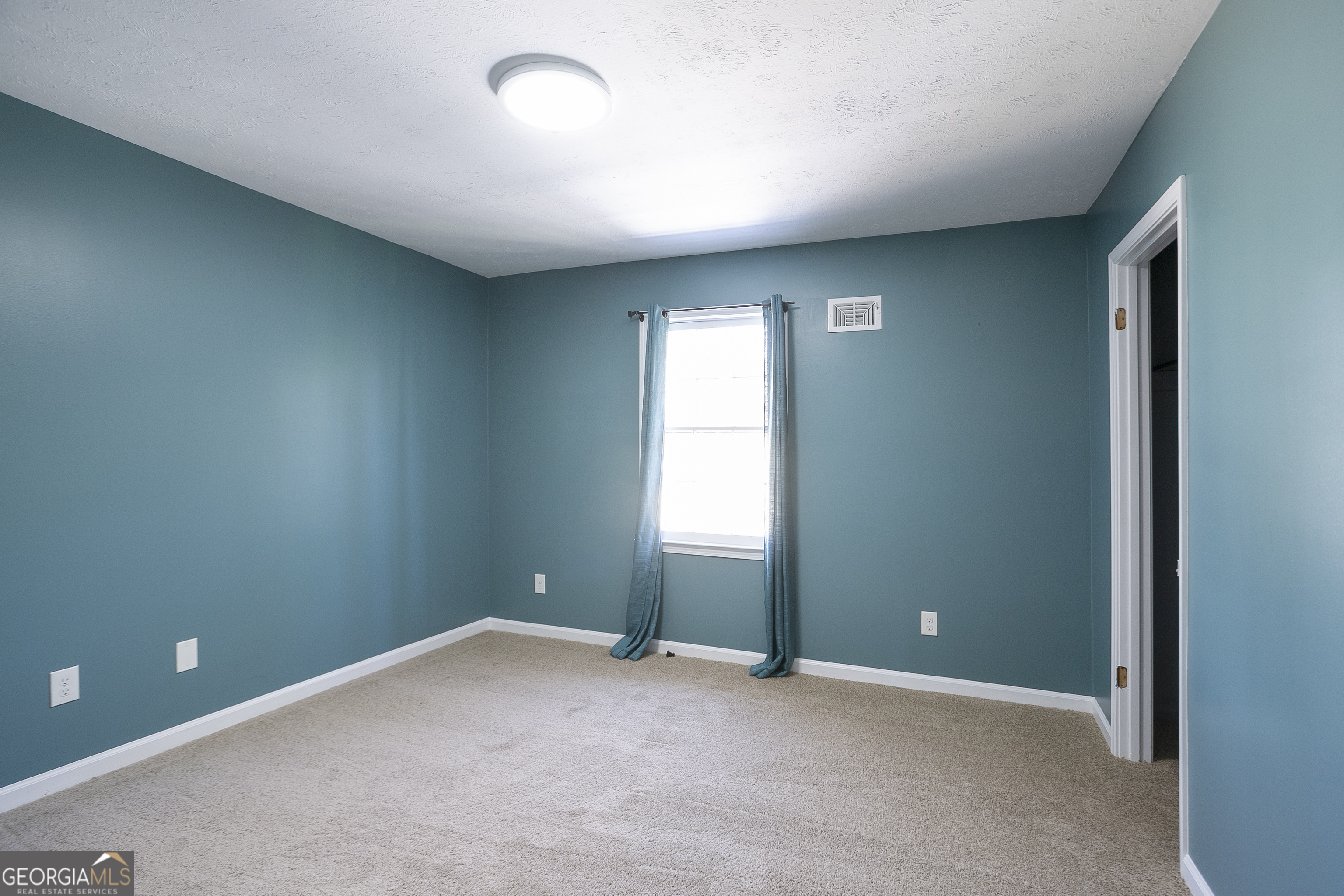 3959 Emerald Springs Court, Unit 3 Decatur, GA 30035 - Photo 14 of 27 an empty room with a window
