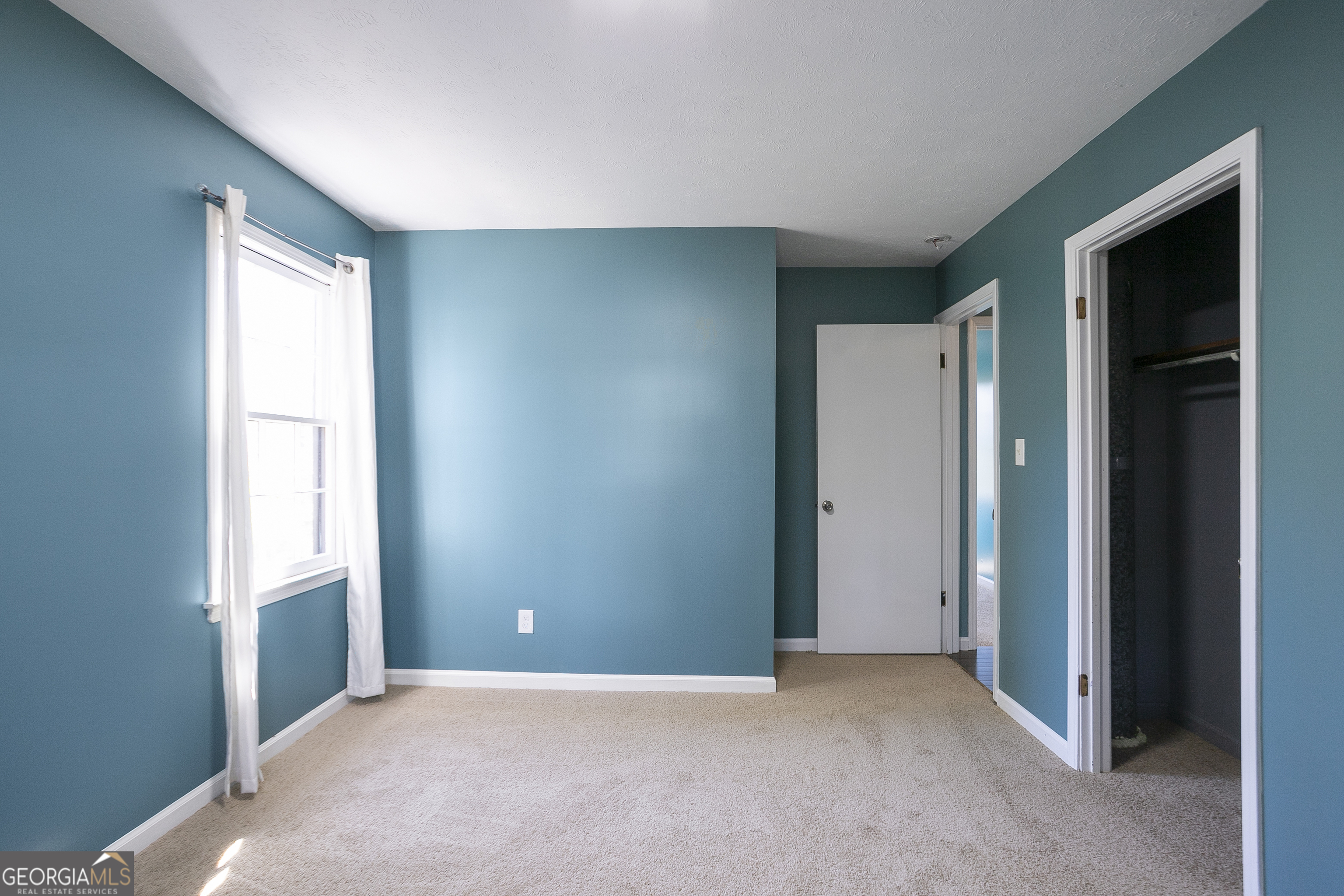 3959 Emerald Springs Court, Unit 3 Decatur, GA 30035 - Photo 17 of 27 an empty room with windows and closet
