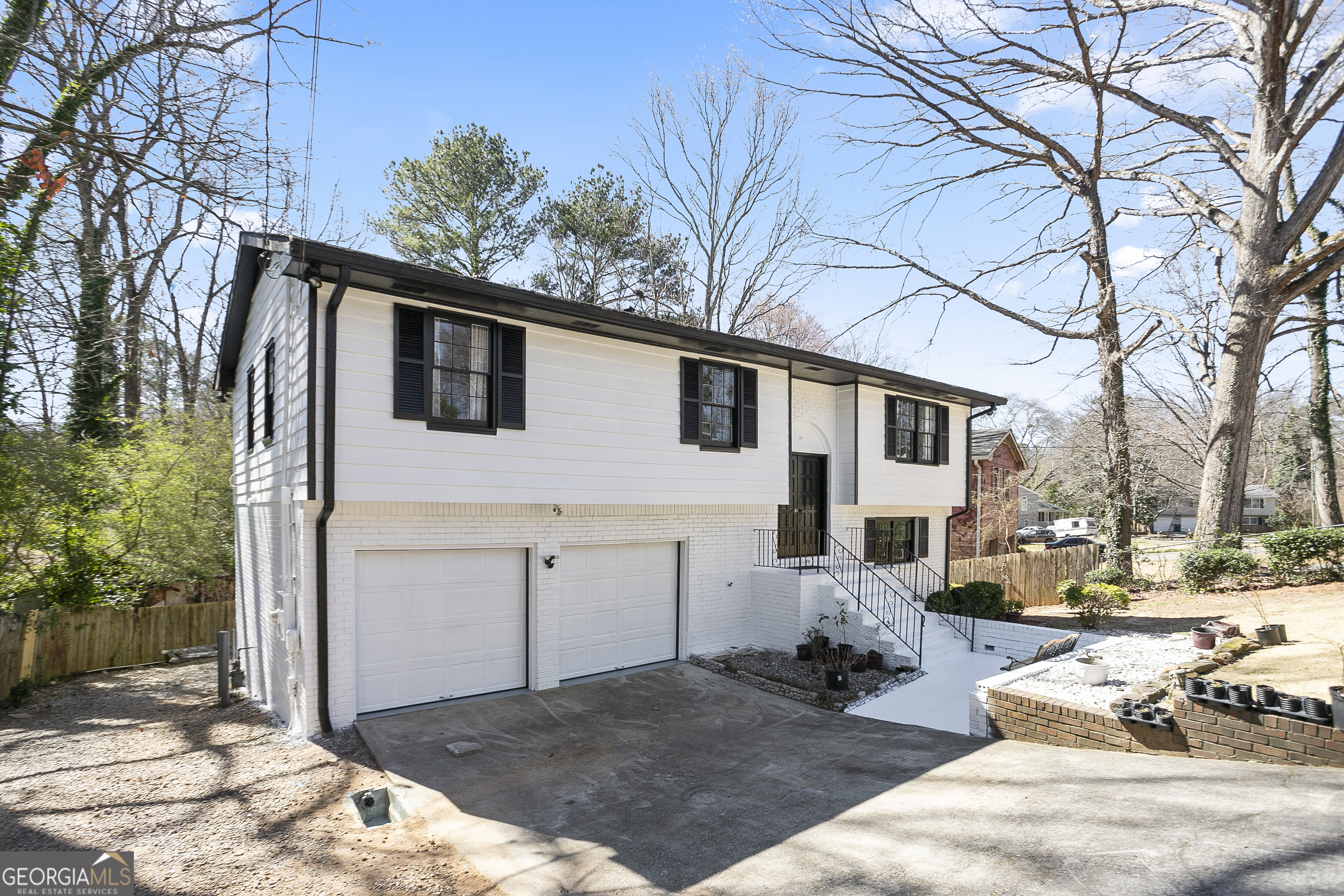 3959 Emerald Springs Court, Unit 3 Decatur, GA 30035 - Photo 2 of 27 a view of a house with a yard covered in snow