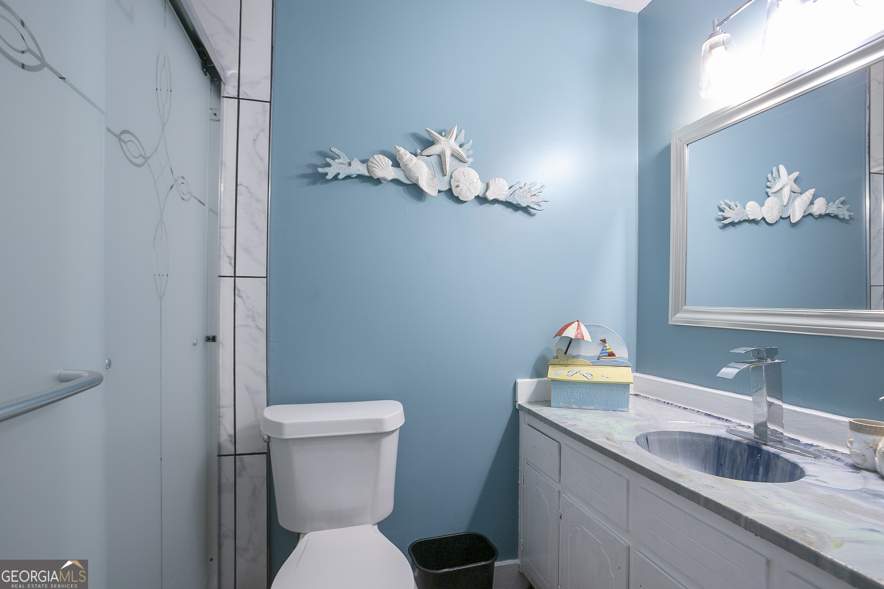 3959 Emerald Springs Court, Unit 3 Decatur, GA 30035 - Photo 22 of 27 a bathroom with a sink a toilet and a mirror
