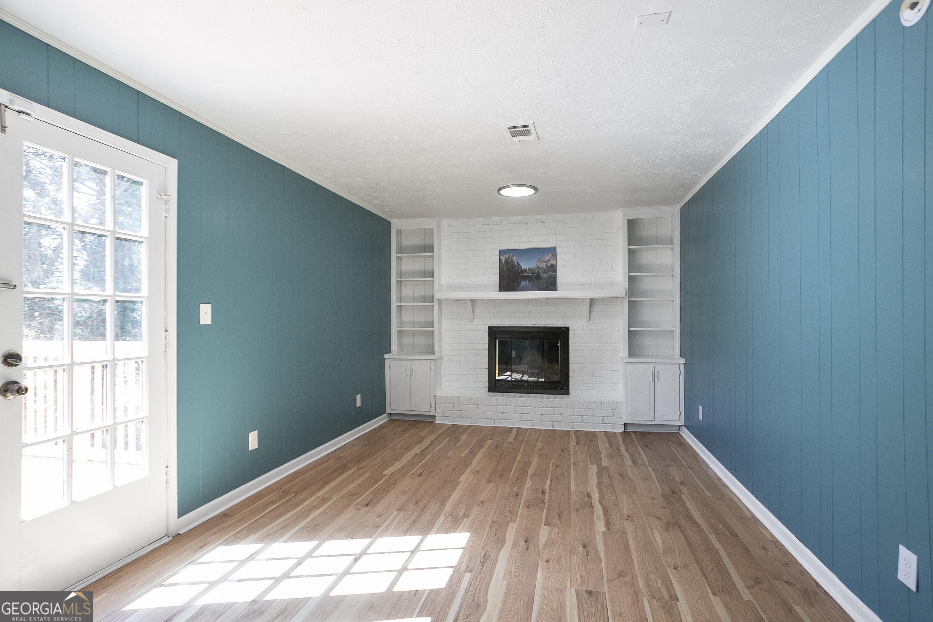 3959 Emerald Springs Court, Unit 3 Decatur, GA 30035 - Photo 24 of 27 a view of empty room with wooden floor and fireplace