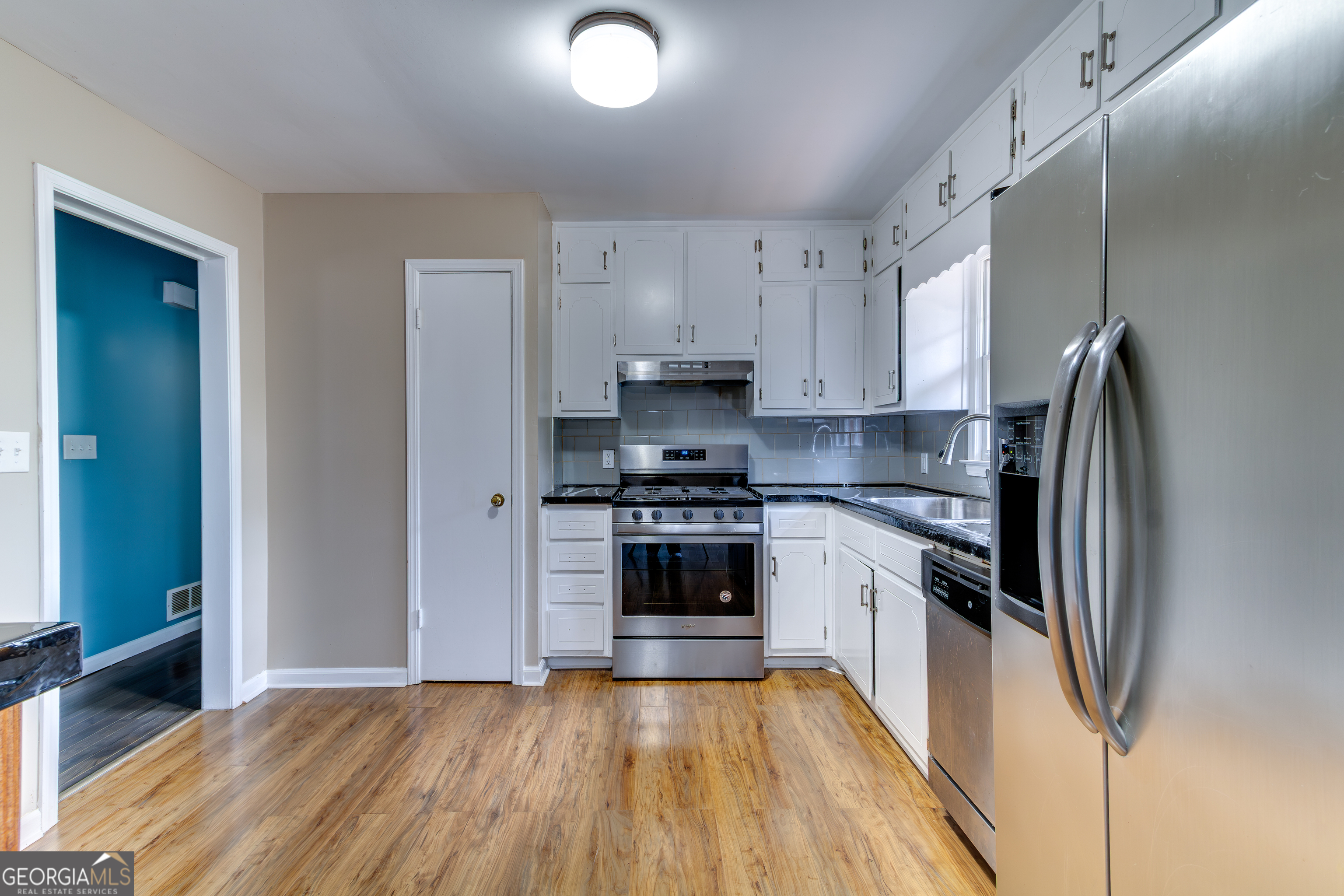 3959 Emerald Springs Court, Unit 3 Decatur, GA 30035 - Photo 6 of 27 a kitchen with stainless steel appliances granite countertop a stove and a refrigerator
