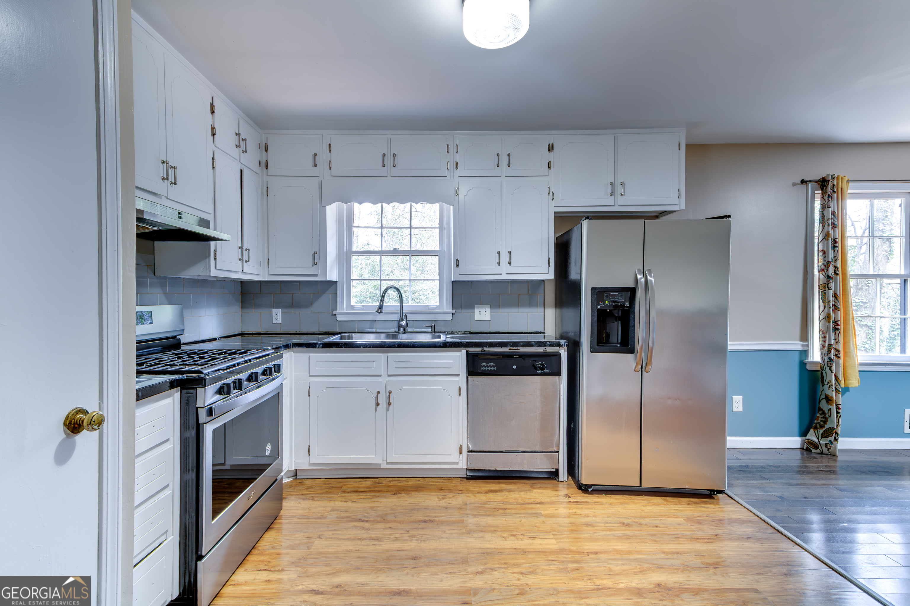 3959 Emerald Springs Court, Unit 3 Decatur, GA 30035 - Photo 7 of 27 a kitchen with stainless steel appliances granite countertop a stove a refrigerator and a sink