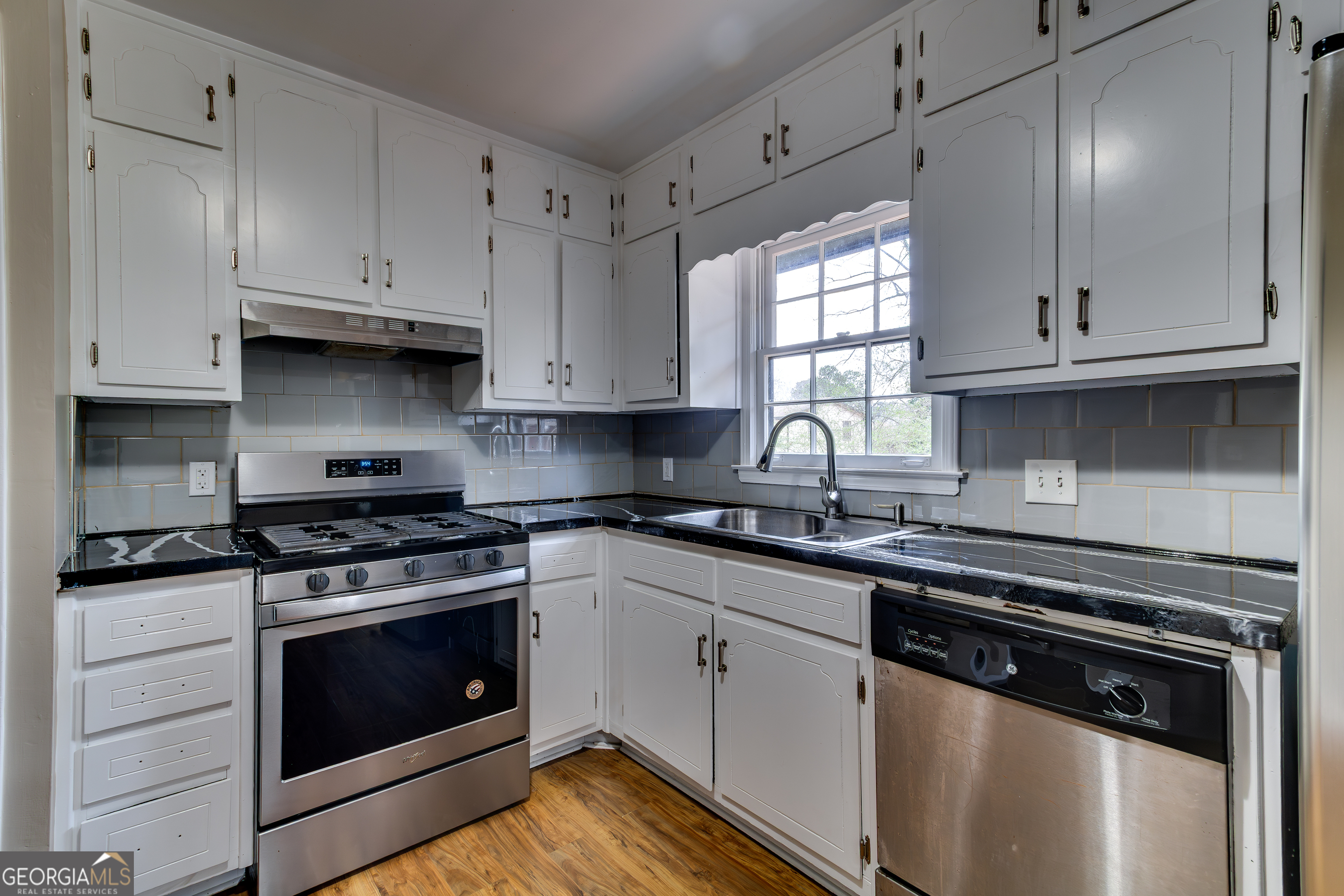 3959 Emerald Springs Court, Unit 3 Decatur, GA 30035 - Photo 8 of 27 a kitchen with granite countertop white cabinets and white appliances