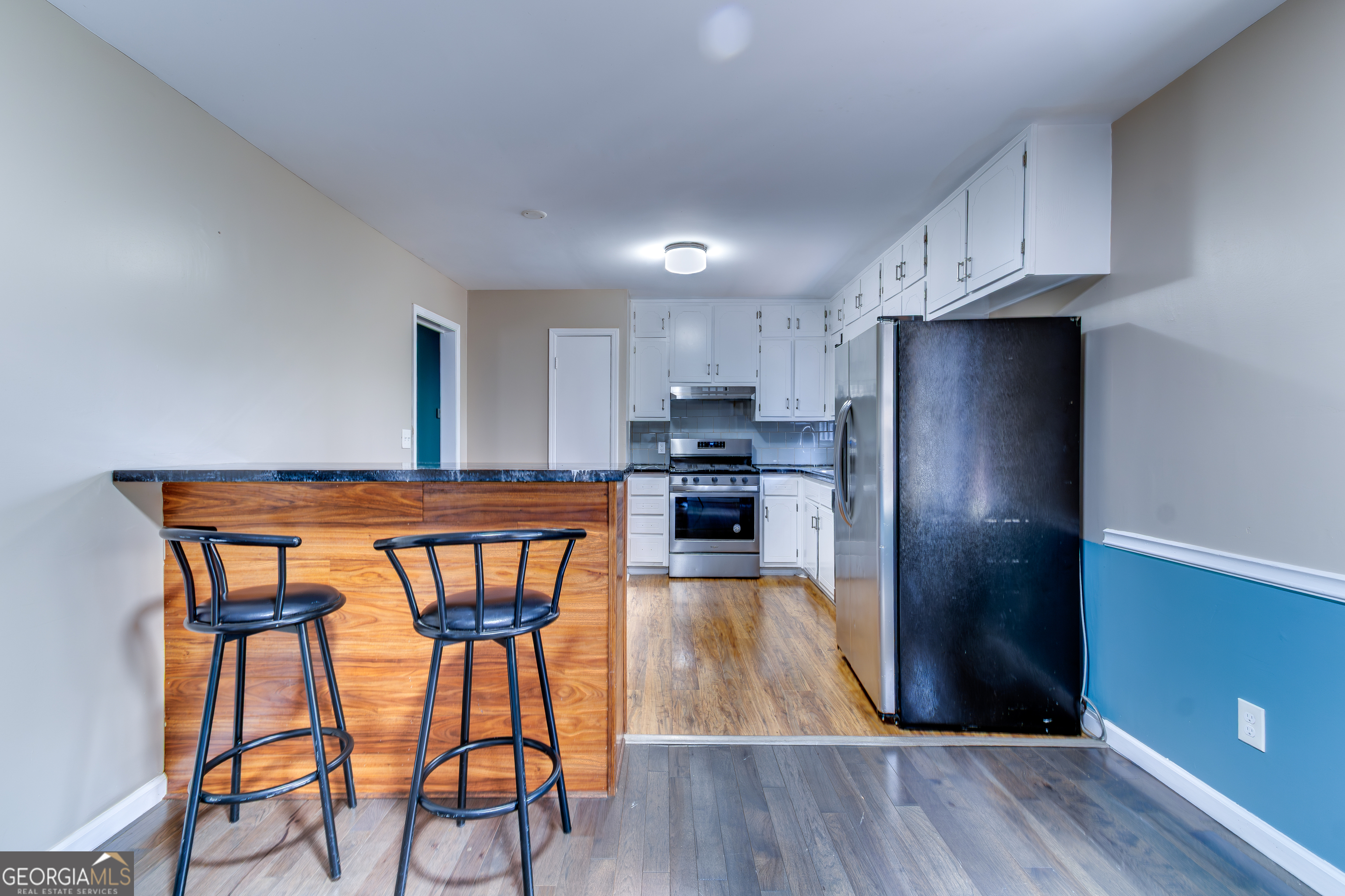3959 Emerald Springs Court, Unit 3 Decatur, GA 30035 - Photo 10 of 27 a kitchen with stainless steel appliances a dining table chairs refrigerator and sink